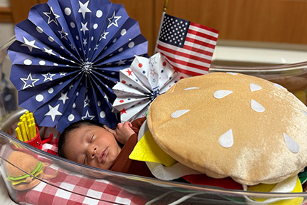 NICU baby dressed as burger for July 4th