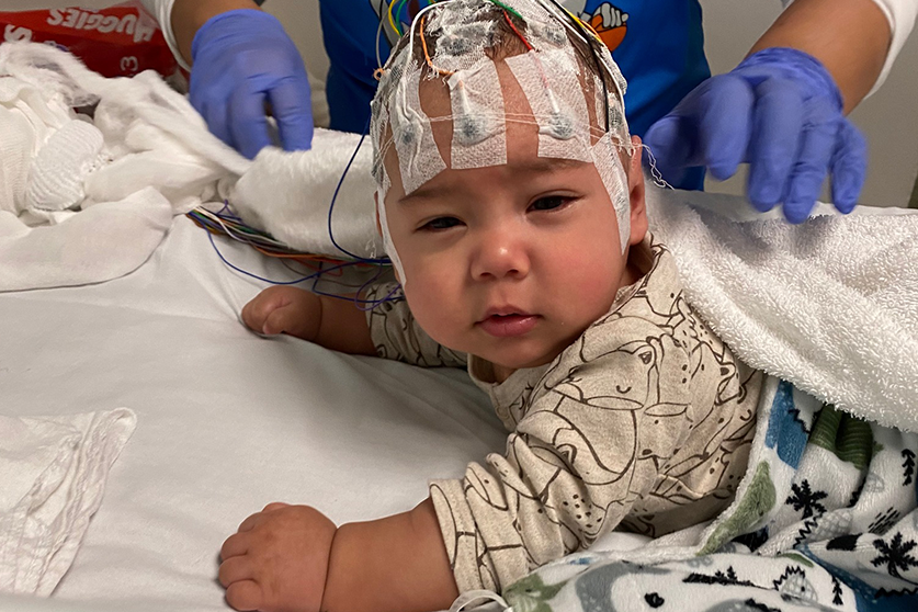 Giovanni being fitted with electrodes on head