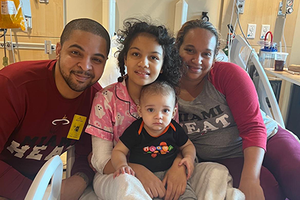 Jestina and family in hospital room
